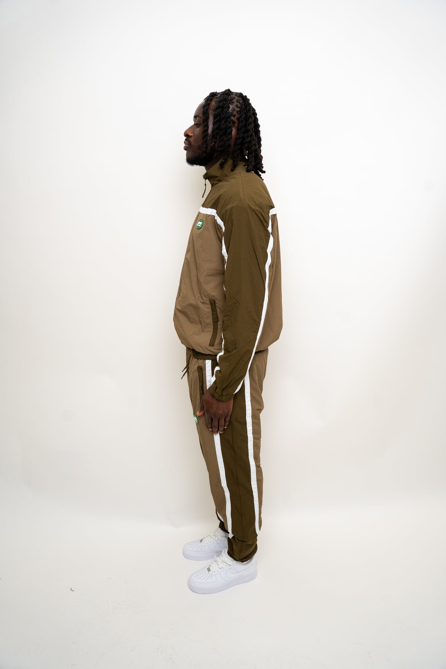 khaki tracksuit
brown nylon tracksuit
RPR DopeBoy set
military green tracksuit
unisex two-piece activewear
full zip tracksuit with logo
lightweight streetwear set
mesh-lined tracksuit
nylon jacket and pants set
urban utility style tracksuit