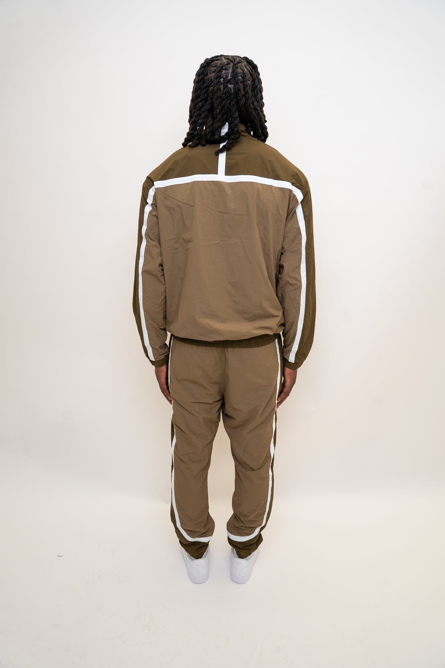 khaki tracksuit
brown nylon tracksuit
RPR DopeBoy set
military green tracksuit
unisex two-piece activewear
full zip tracksuit with logo
lightweight streetwear set
mesh-lined tracksuit
nylon jacket and pants set
urban utility style tracksuit