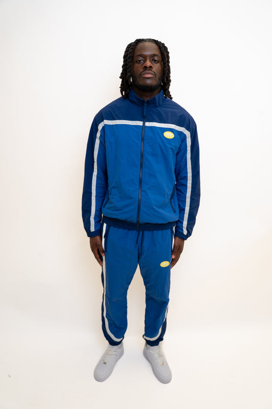 ocean blue tracksuit
navy nylon tracksuit
men’s full tracksuit set
unisex drawstring tracksuit
mesh lined activewear
zip-up track jacket and pants
relaxed fit tracksuit
DopeBoy tracksuit
streetwear active set
lightweight sports tracksuit