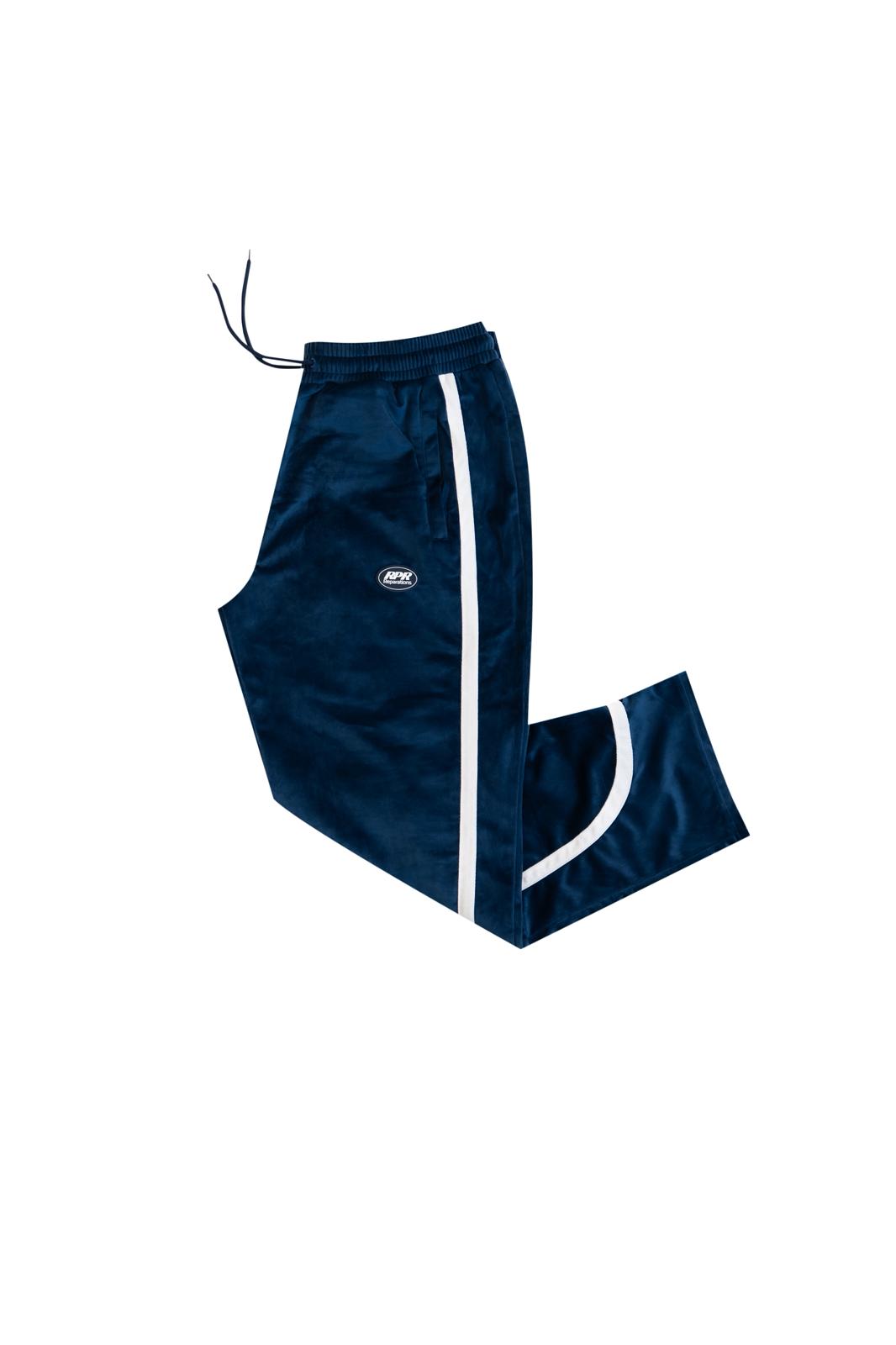 Navy blue velour track pants with white side stripes, folded athletic style