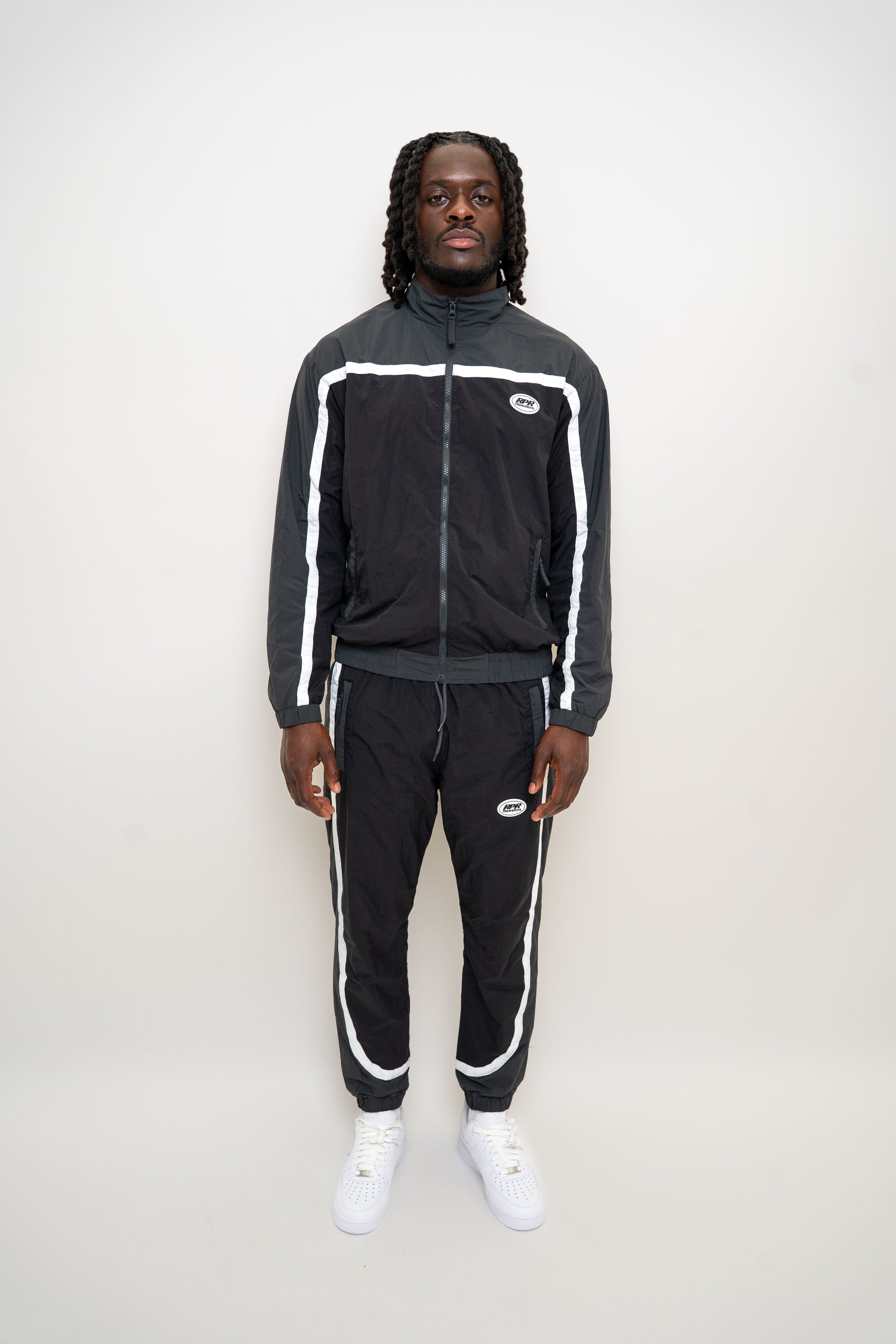 black nylon tracksuit

charcoal grey tracksuit set

RPR DopeBoy tracksuit

full zip athletic set

unisex streetwear tracksuit

mesh lined jacket and pants

relaxed fit activewear

tapered jogger set

men’s black tracksuit

lightweight nylon two-piece