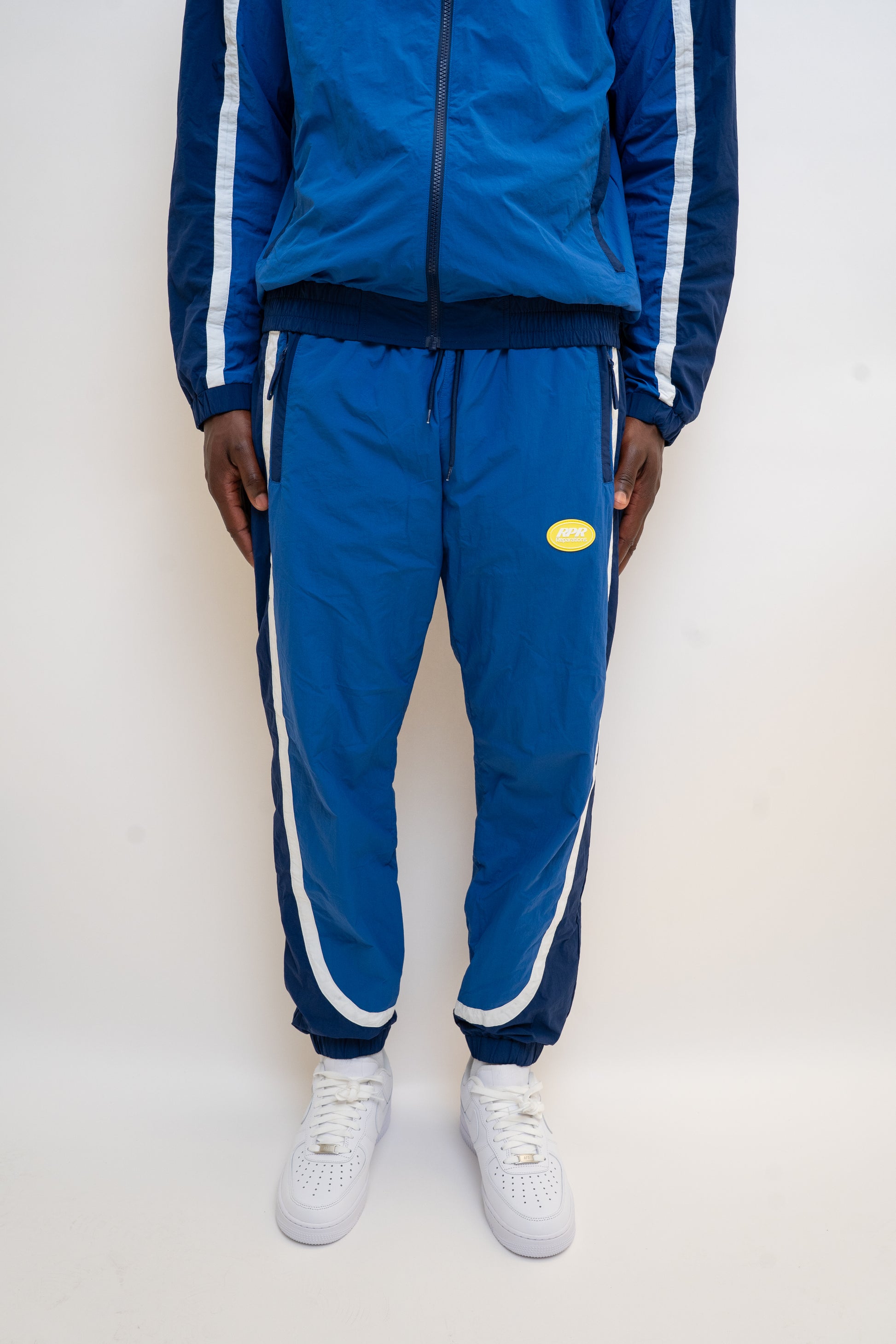 ocean blue tracksuit

navy nylon tracksuit

men’s full tracksuit set

unisex drawstring tracksuit

mesh lined activewear

zip-up track jacket and pants

relaxed fit tracksuit

DopeBoy tracksuit

streetwear active set

lightweight sports tracksuit