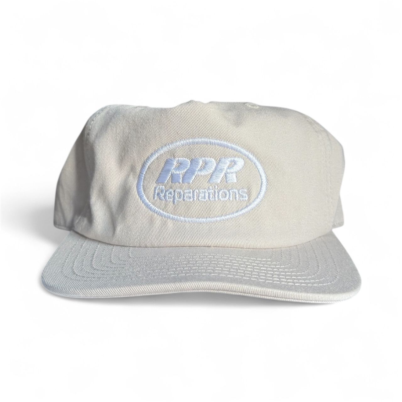 Beige cap with 'RPR Repetitions' logo on a white background