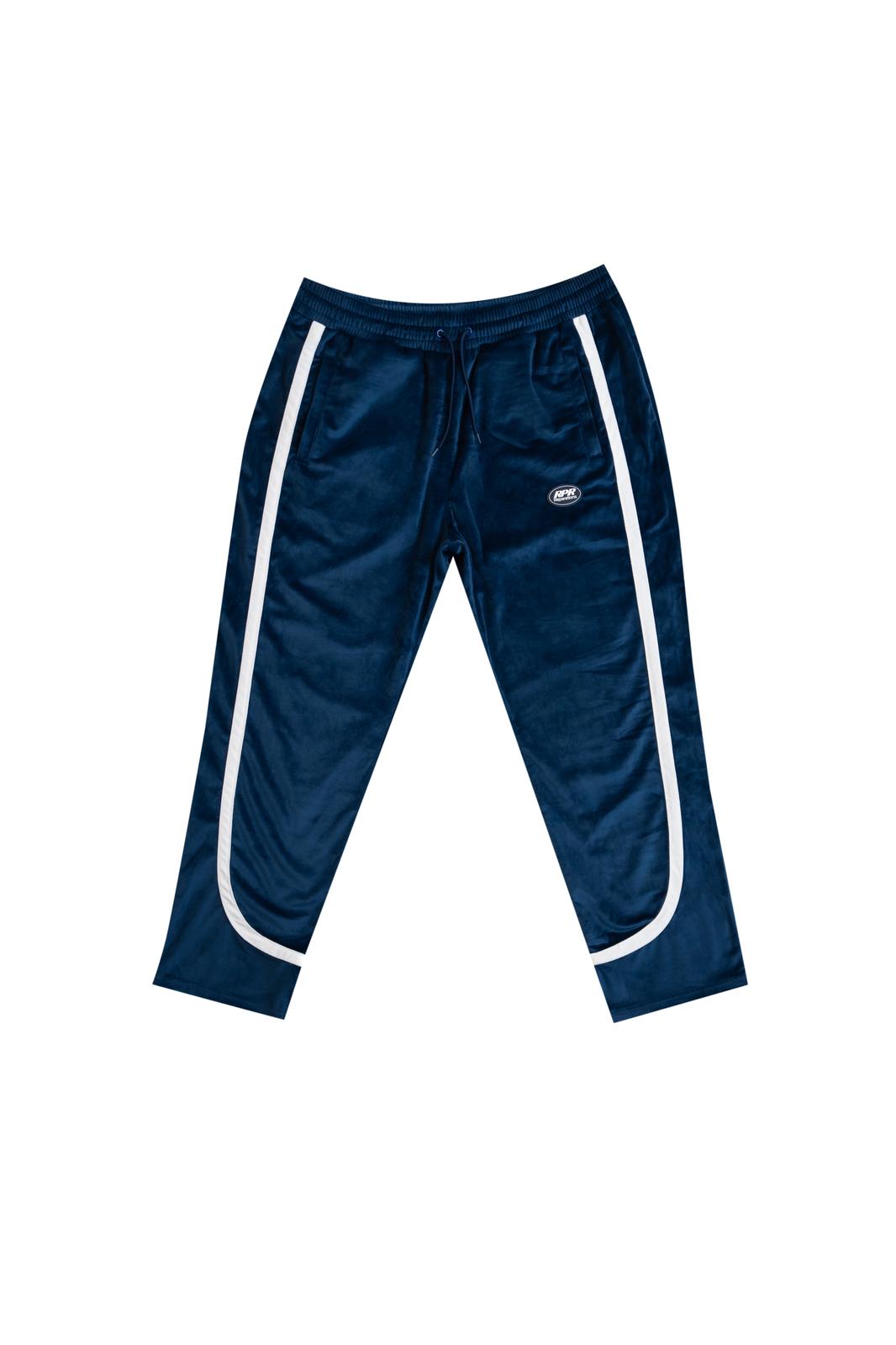 Front view of navy blue velour track pants with white curved stripe panels